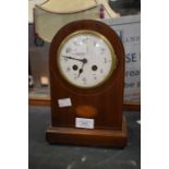 An Edwardian dome-shaped mahogany mantle clock with batwing inlay and Arabic numerals