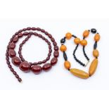 A cherry amber type necklace of oval graduated beads, the largest approx 38 x 20mm to 10 x 8mm