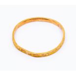 A 9ct gold bangle, engraved, dented total gross weight approx 4.5gms  boxed