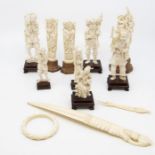 Nine carved ivory okimonos, carved ivory paper knife; bangle; etc