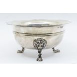 A Georgian style silver sugar bowl, wavy rim above upper rib, on three lion's head and paw feet,