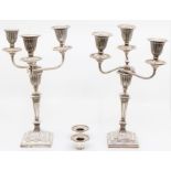 A pair of Edwardian Neo-Classical style silver candelabra, urn shaped sconces above tapering