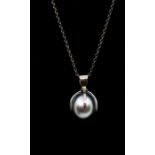 An 18ct pearl pendant necklace, the claw setting holding a Tahitian grey pearl length approx 17mm