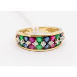 A 9ct gold and stone set ring, set with a central row of small brilliant cut claw set diamonds,