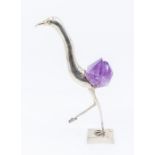 A Brazilian 900 standard silver and amethyst quartz mounted model of a stork like bird, the base