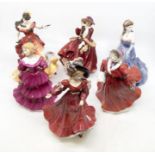 A collection of nine figurines including ROyal Doulton ladies, Coalport and another