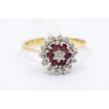 A ruby and diamond 18ct gold cluster ring, round form set to the centre with a brilliant cut diamond