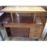 A 1950s teak sideboard and a similar coffee table