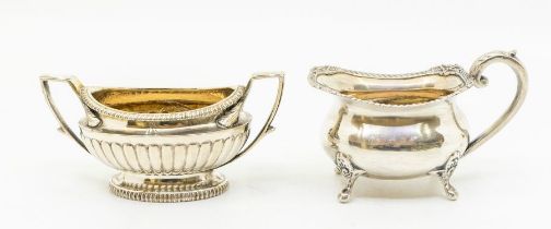 A George III silver two handled sugar bowl, gadroon section, gilt interior, engraved with a crest,