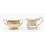 A George III silver two handled sugar bowl, gadroon section, gilt interior, engraved with a crest,