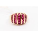 A ruby and 9ct gold ring, comprising five rows of calibre cut rubies channel set edges set with
