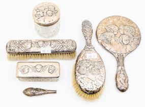An early 20th Century silver mounted dressing table set, all chased with Reynold's Angels.,