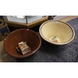 Two large Victorian earthenware tapering mixing bowls, one with cream coloured glaze together with a