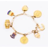 A 9ct gold charm bracelet and charms including Scorpio and St Christopher charms, hearts locket etc,