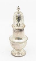 A George V silver caster, plain baluster form with detachable pierced and engraved cover, urn shaped