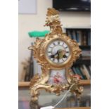 Late 19th Century French spelter and gilt mantle clock with hand painted porcelain plaque below