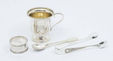 A collection of silver to include: an Elizabeth II silver christening mug, Birmingham, 1957;