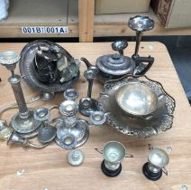 A collection of silver plated items, to include:- small trophies, candlesticks a three piece tea