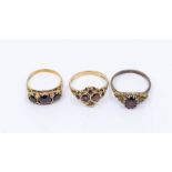 Three garnet rings, including a 9ct gold cluster, size O1.2,(outer stone damaged) a 9ct gold three