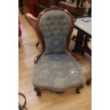 A Victorian mahogany parlour chair, button back with flower detail to back rest, on castors