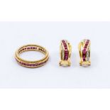 A 14k ruby eternity ring, the centre channel set with a row of calibre cut rubies, size N11/2, total