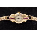 A Ladies Art Deco style 9ct gold ruby set dress watch, comprising a round champagne dial with