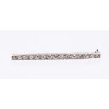 A 20th century diamond set platinum bar brooch, comprising fifteen old cut graduated diamonds, total