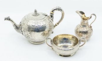 A matched Victorian three piece tea service comprising teapot, sugar bowl and milk jug, each body