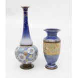 Two early 20th Century Royal Doulton Lambeth blue ground vases, hair line on tall vase on neck