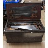 Tool trunk on castors containing all wooden handled tools including a plane, chisels, drill, set