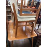 A 1950s kitchen table and four chairs in teak, with missing leaf