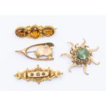 A citrine and 15ct gold brooch, set with three oval cut citrines, with floral accents, length approx