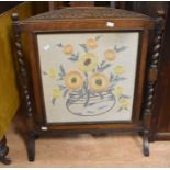 A wooden firescreen circa 1920's with textile panel decorated with sunflowers in a vase