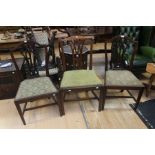 A pair of George III mahogany lyre back dining chairs; and another (3)