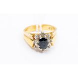 An 18ct gold mounted sapphire and diamond ring, with central oval cut sapphire, size M1/2, total