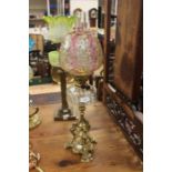 Early 20th Century brass tripod body and clear glass oil section with ruby and green etched shade
