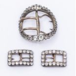 Three 18th Century Georgian shoe buckles, comprising a single large oval buckle in white metal and