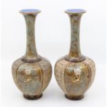 Pair of early 20th Century Royal Doulton Lambeth bluster vases with flower detail, one has hair line