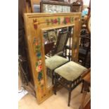 A large gilt mirror with handpainted flowers along with a Victorian piano stool