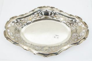 An Edwardian silver lozenge shaped bowl, the raised sides pierced with scrolling foliate decoration,