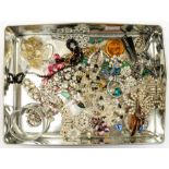 A collection of vintage costume jewellery including paste set dress clips, brooches, Essex type