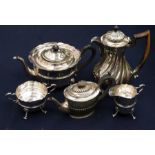 A George III style EPNS three piece tea service comprising teapot, milk jug and creamd jug, plain