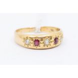 A Victorian ruby and diamond 18ct gold ring, star set with alternate old cut diamonds and oval cut