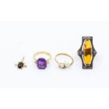 An 18ct amethyst ring with emerald cut amethyst and three small diamonds set to each shoulder,