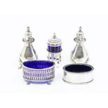 A group of Georgian style silver condiments to include: two oval salts with blue glass liners,