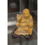 Soapstone Buddha on a wooden base