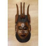 A large African tribal wall hanging face mask