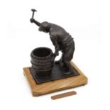 Bronzed figure of the Burton Cooper on wooden stand