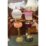 Two Victorian brass and glass oil lamps with shades and funnels