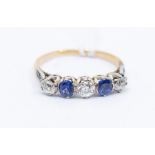 A gold five stone diamond and sapphire ring, two round cut sapphires and three old cut diamonds,